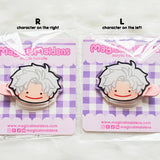 Two acrylic hair clips with a character design on a checkered background, branded 'Magical Maidens'.